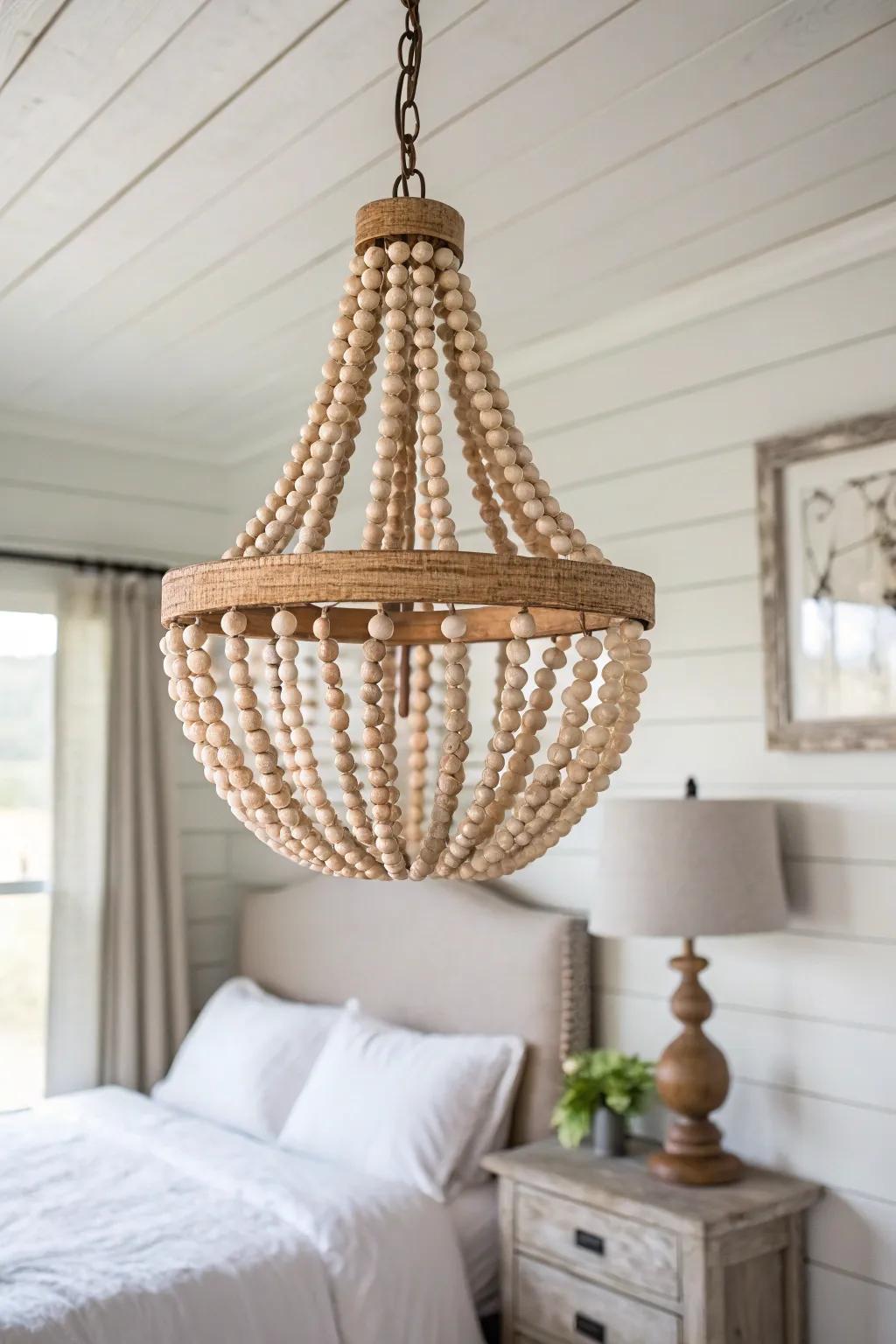 Wood bead pendant light adds warm, beachy texture—perfect for a coastal farmhouse bedroom.