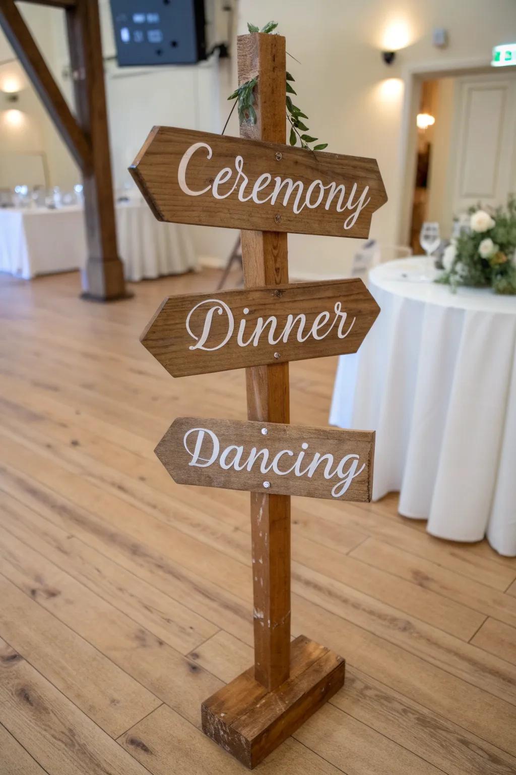 Rustic indoor signpost with hand-lettered arrows—ceremony, dinner, dancing in one.