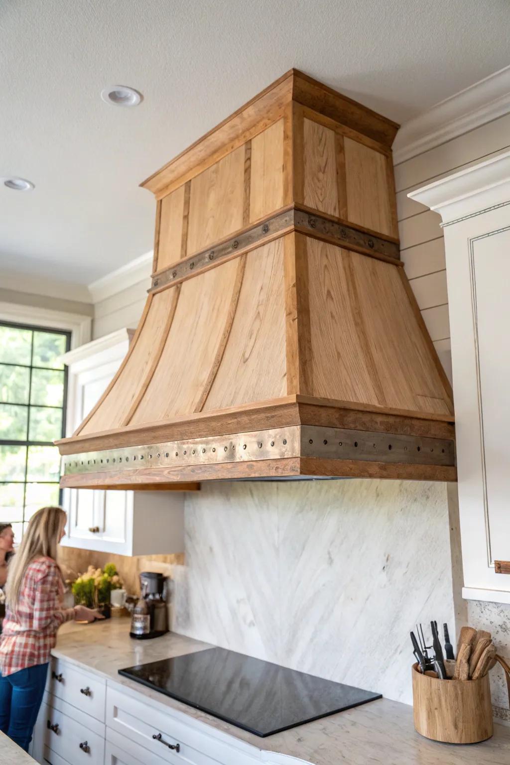 A thin aged copper band elevates a rustic oak hood—warm patina, clean lines, timeless charm.