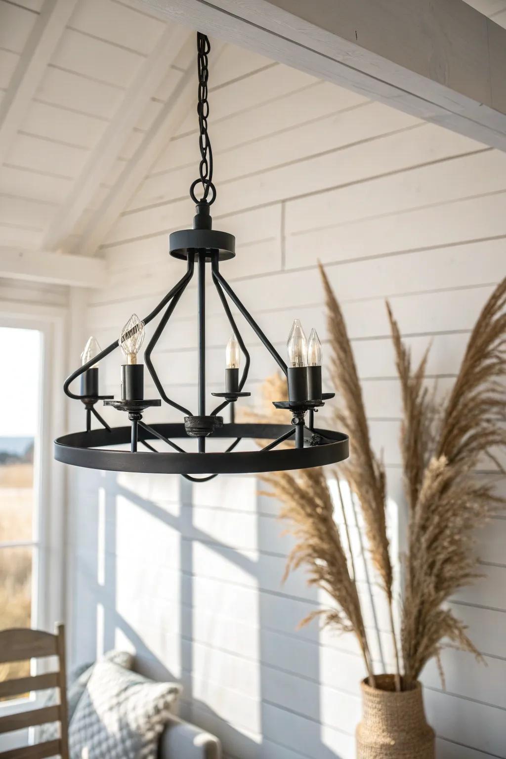 Matte black metal lighting adds crisp contrast and modern structure to a white farmhouse room.